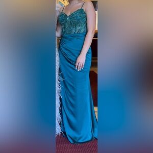 Emerald gown with beaded corset top and side cape.